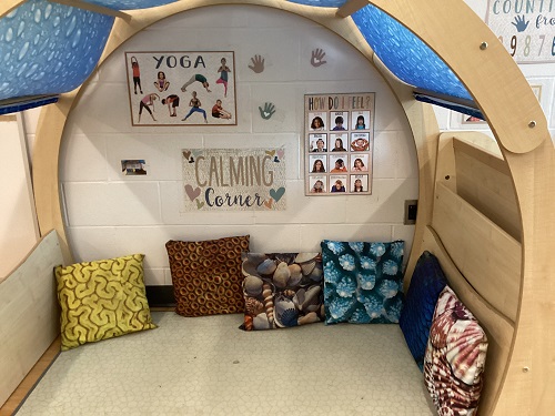 A tent filled with pillows and self-regulation posters.