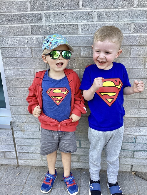 Two children standing together on the playground.