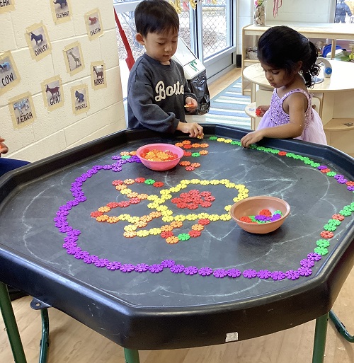 children creating art with colourful plastic connectors