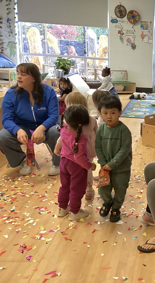 children at their Diwali party standing in the confetti