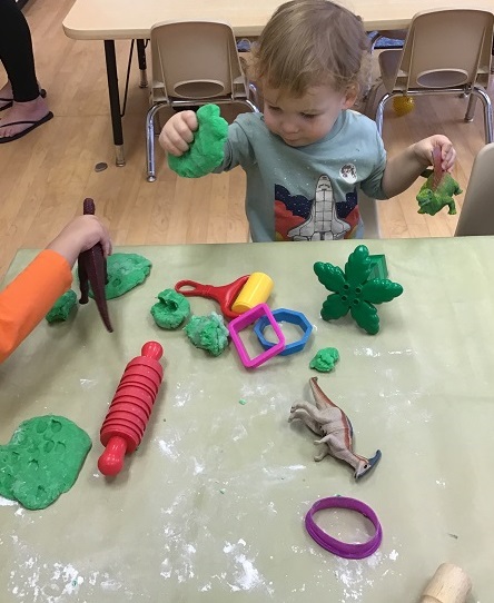 child playing with playdough