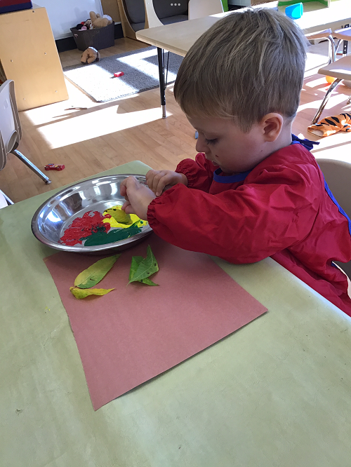 child painting with some leaves