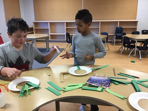 Two children sharing craft materials
