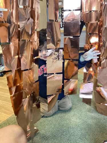 Playing peek a boo through the tinsel