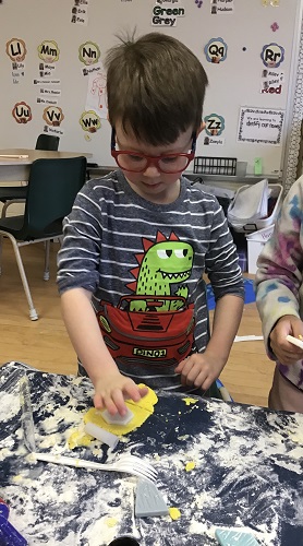 boy shaping his dough with cutter