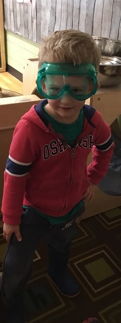 Preschool boy posing for a photo wearing safey glasses