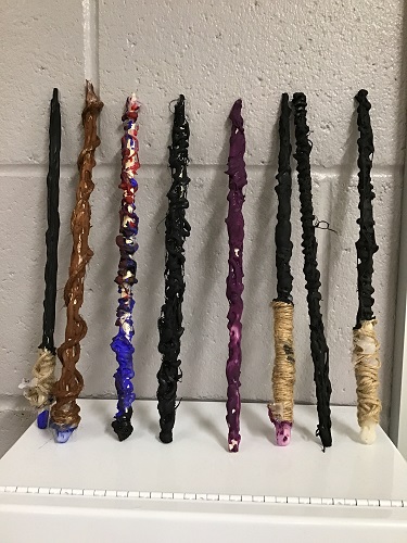 Hand made wands lined up against a wall