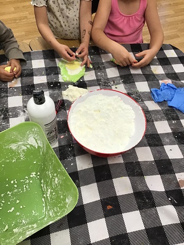 Children at a table playing with cloud dough