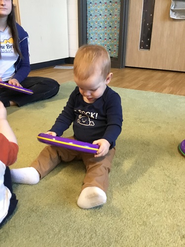 A child holding a musical instrument