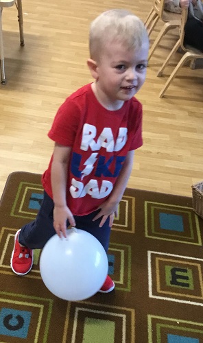 A child standing with a balloon