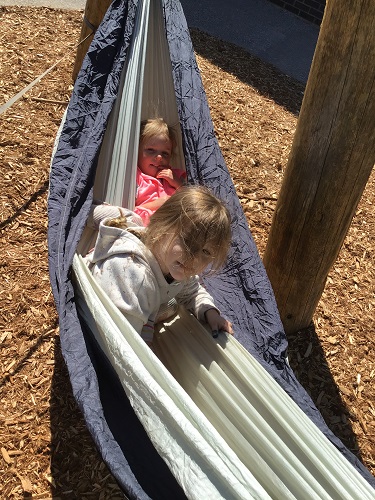 Two children in a hammock outside