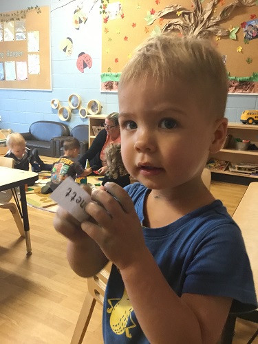 A child holding his name tag