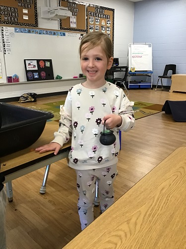 A child carrying a small cauldron