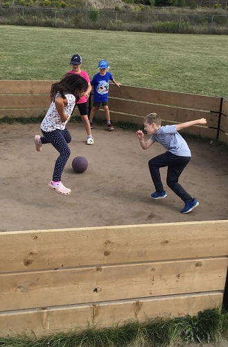 Children in the GaGa Ball pit playing with a ball