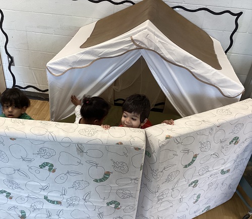 Children peeking out from behind the Nugget