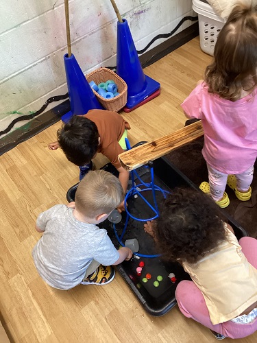 Children using the ramps and scoops during water play