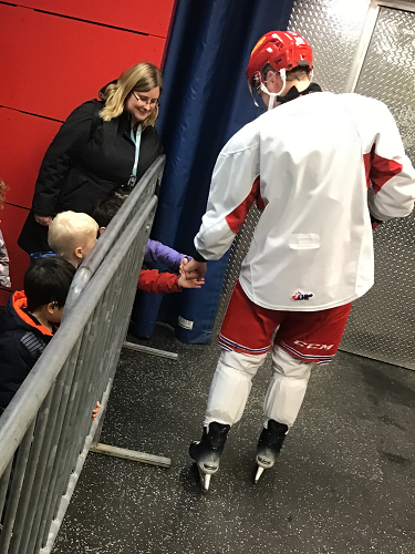 Getting a high five from a hockey player