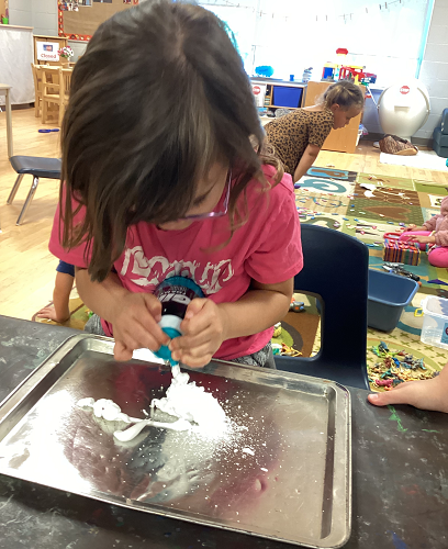 A child spraying shaving cream