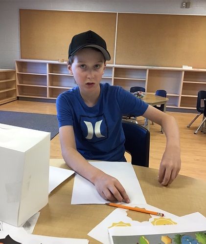A child working at a table with paper