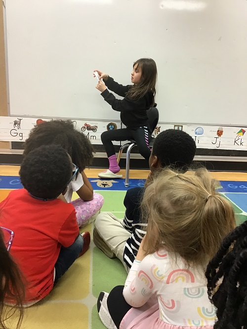 child in black presenting her show and share