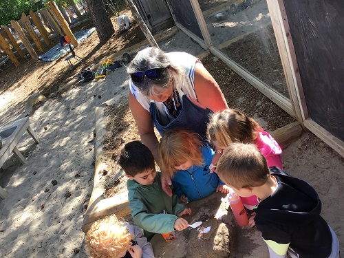 Educator helping children