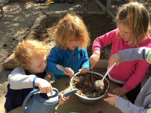 children mixing mud