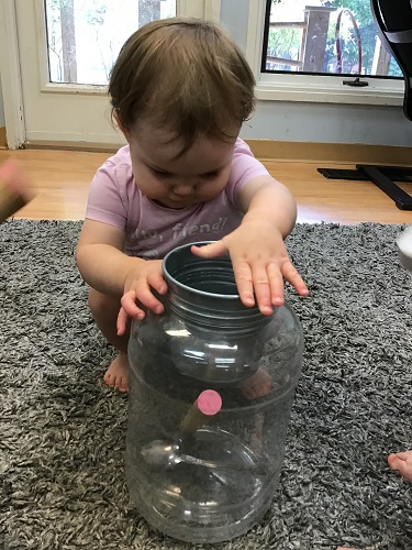 Child placing object in can