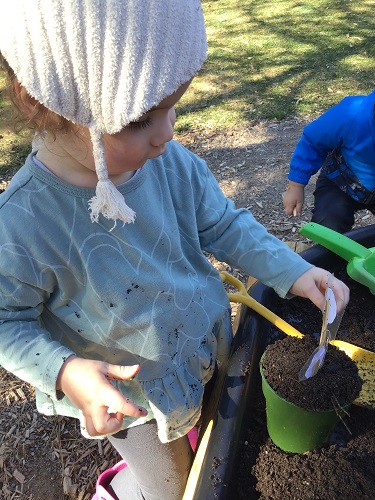 Child digging in soil
