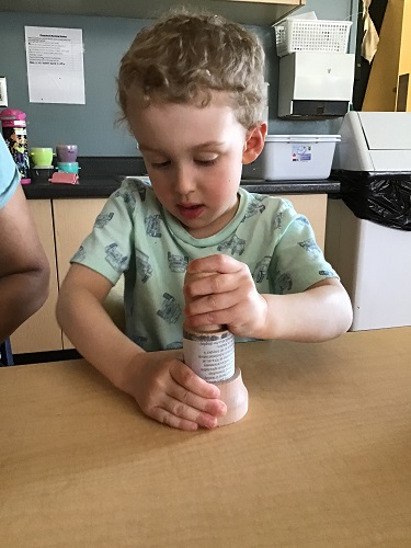 preschool child using the pot maker