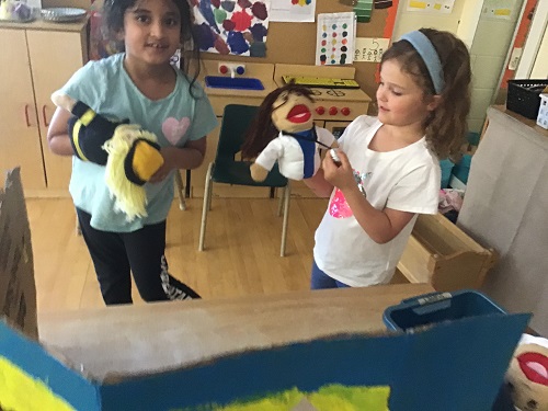 2 JKK girls playing puppets