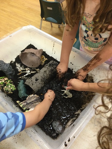 Camp friends playing in sensory table habitat 