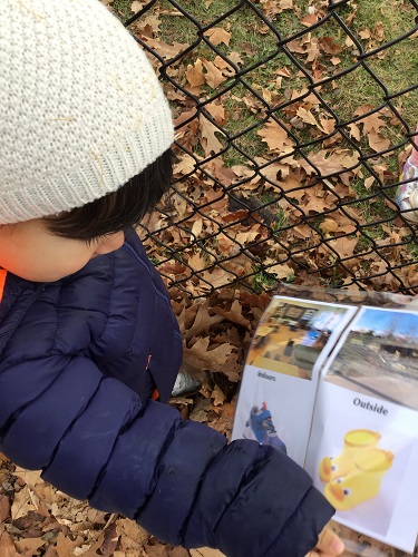 Toddler boy pointing at shoes on chart