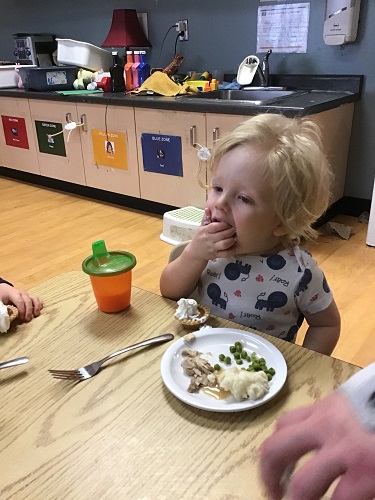 toddler enjoying his pumpkin tart!