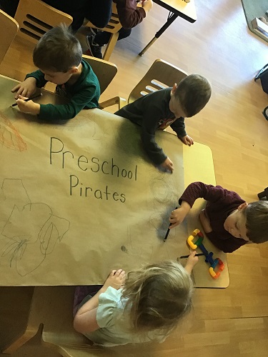 preschool children making pirate flag 