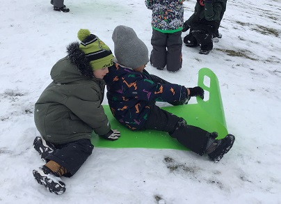 2 JKK boys sledding