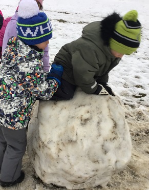 2 JKK boys climbing boulder 