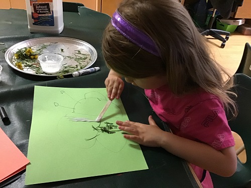 JK girl creating her loose parts butterfly 