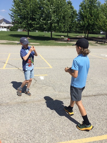 2 school-age boys looking at their character 