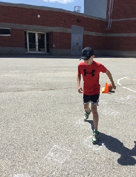 school-age boy competing in hopscotch challenge 