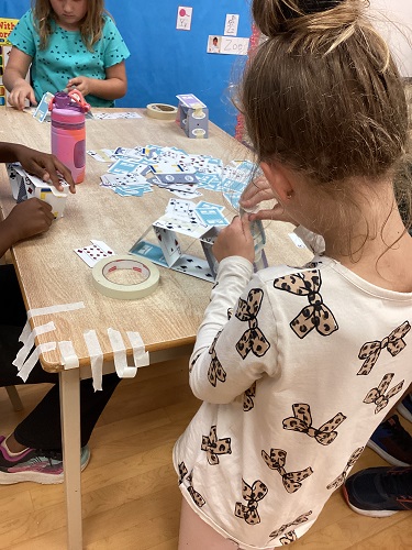 school-age children building with cards