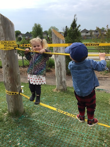 2 toddlers bouncing on ratchet straps 