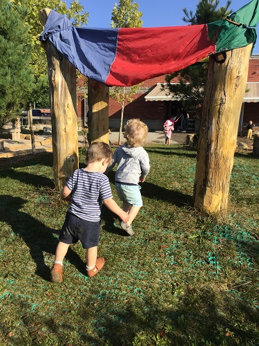 Toddler children running together under tent