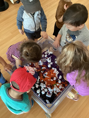 Children explore a sensory bin