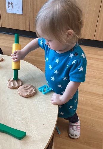 Infants exploring play dough