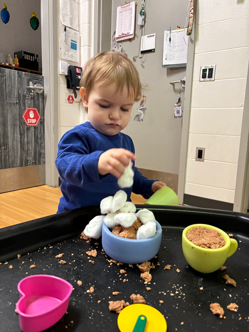 A child engaging with the hot chocolate playdough.