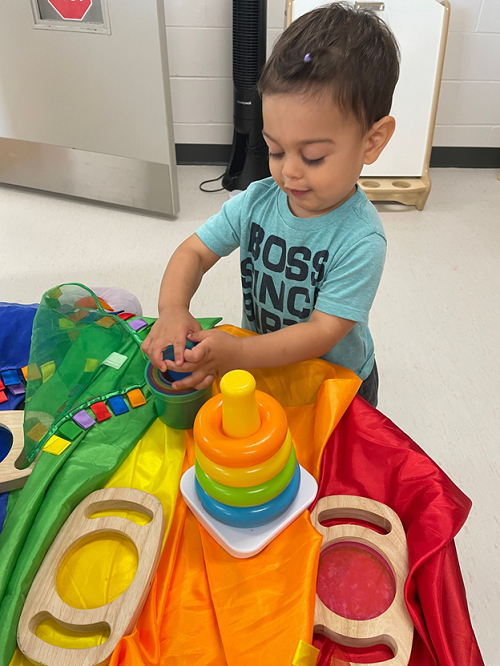 A child exploring different materials