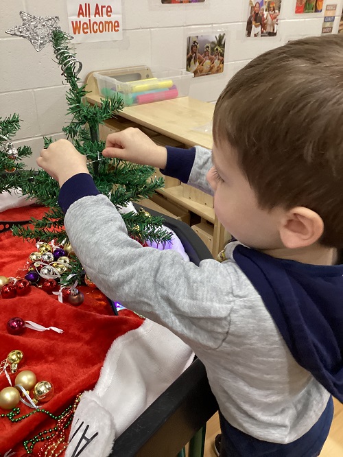 A child decorating their tree