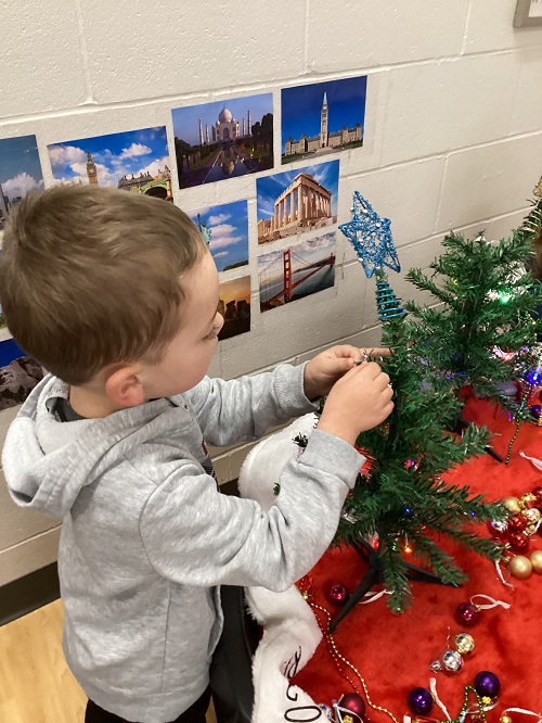 A child decorating their tree.