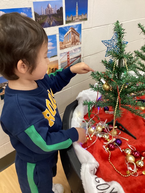 A child decorating their tree.