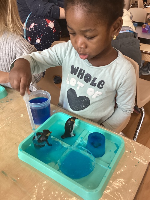 A child working to free their frozen treasure